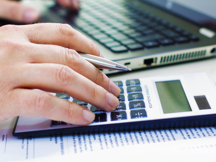 Business man in dark suit whit calculator