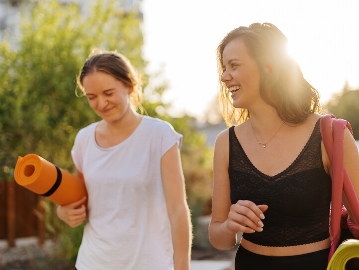 Two young beautiful women in sportswear going to do sports training, gymnastics, yoga